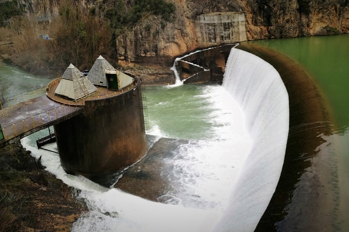 a waterfall going over a body of water