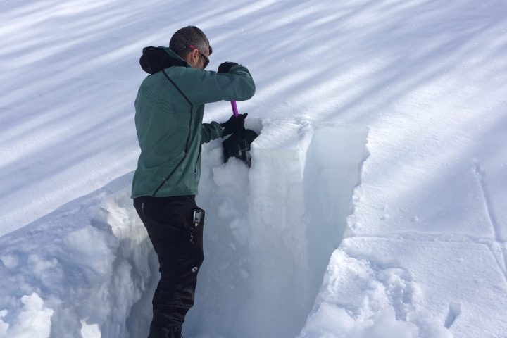 a man riding skis down a snow covered slope