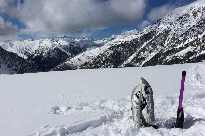 a man standing on top of a snow covered mountain
