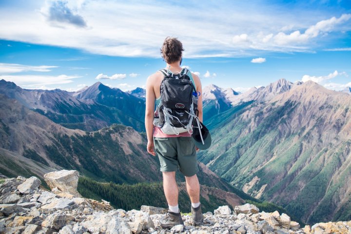 a man standing on a rocky hill