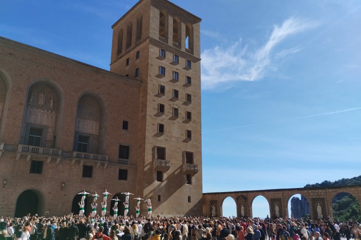 a group of people standing in front of a large building